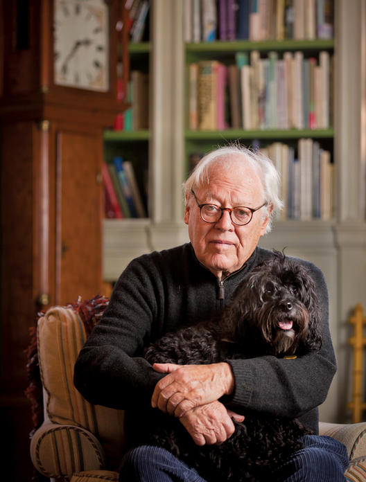 Jason Epstein ’49, ’50 GSAS in his Centre Street living room with his 6-year-old cockapoo, Hamlet. Epstein’s life’s work as an editor and publisher can be seen in the thousands of books that fill his two homes. PHOTO: CHUCK ZOVKO
